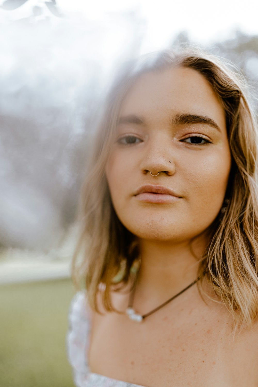 woman in white shirt wearing silver necklace