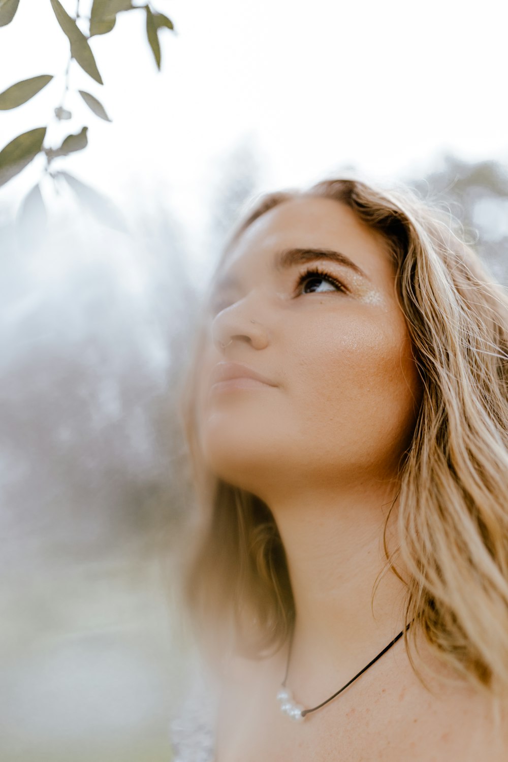 woman in white shirt with white smoke in her face