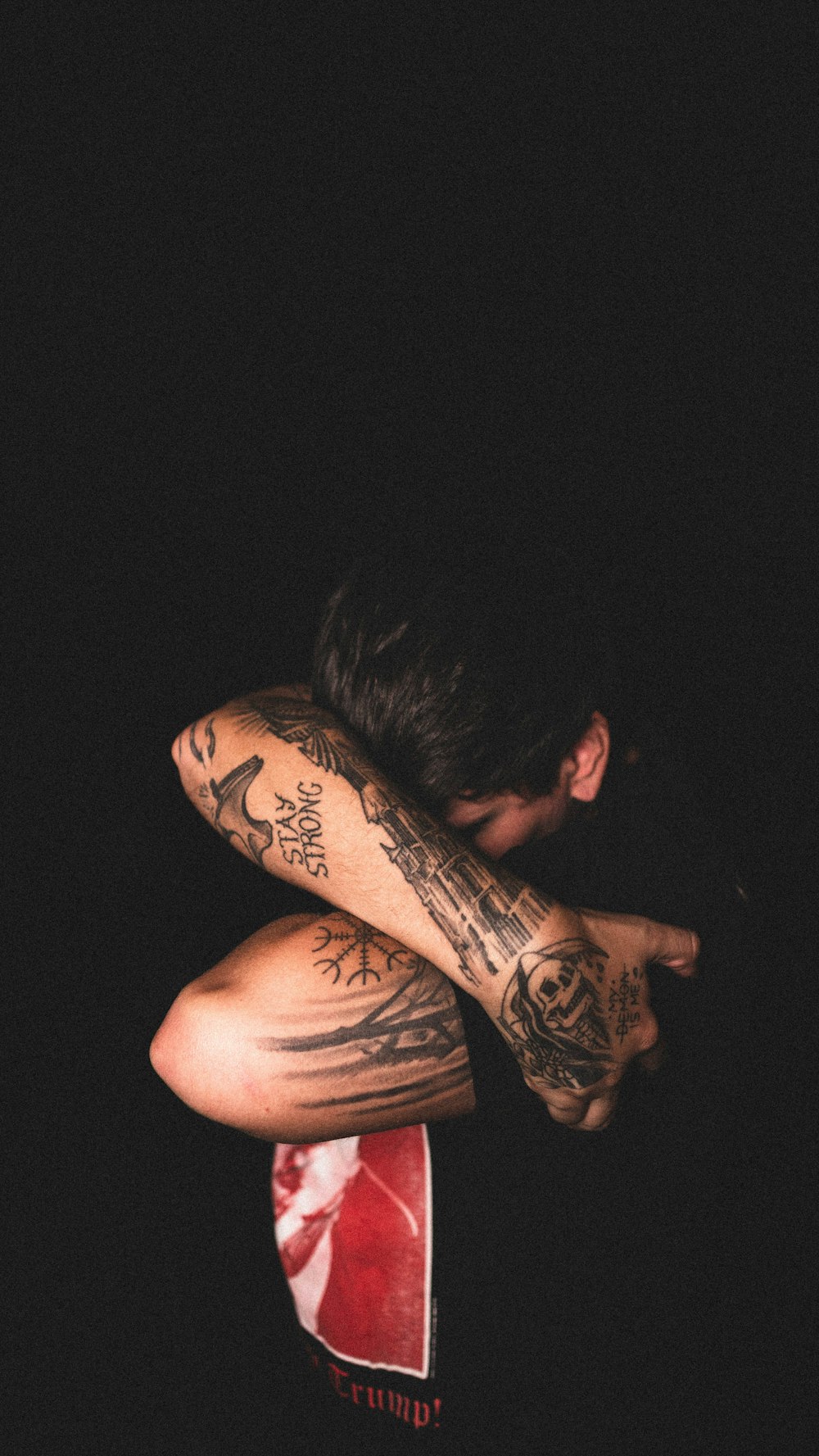 man with black tattoo on his right arm