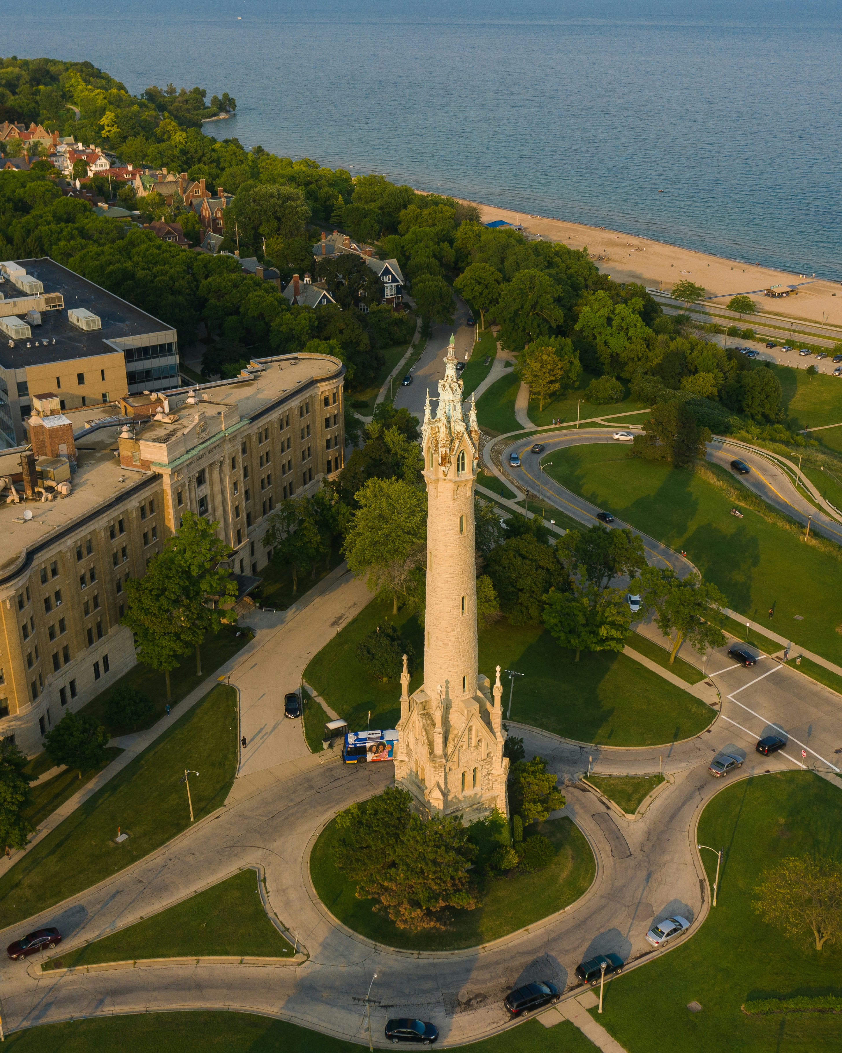aerial view of green grass field near body of water during daytime