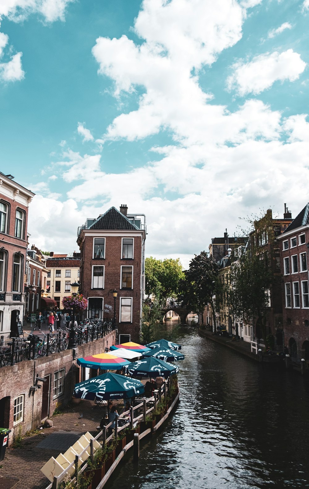 blue boat on river between buildings during daytime