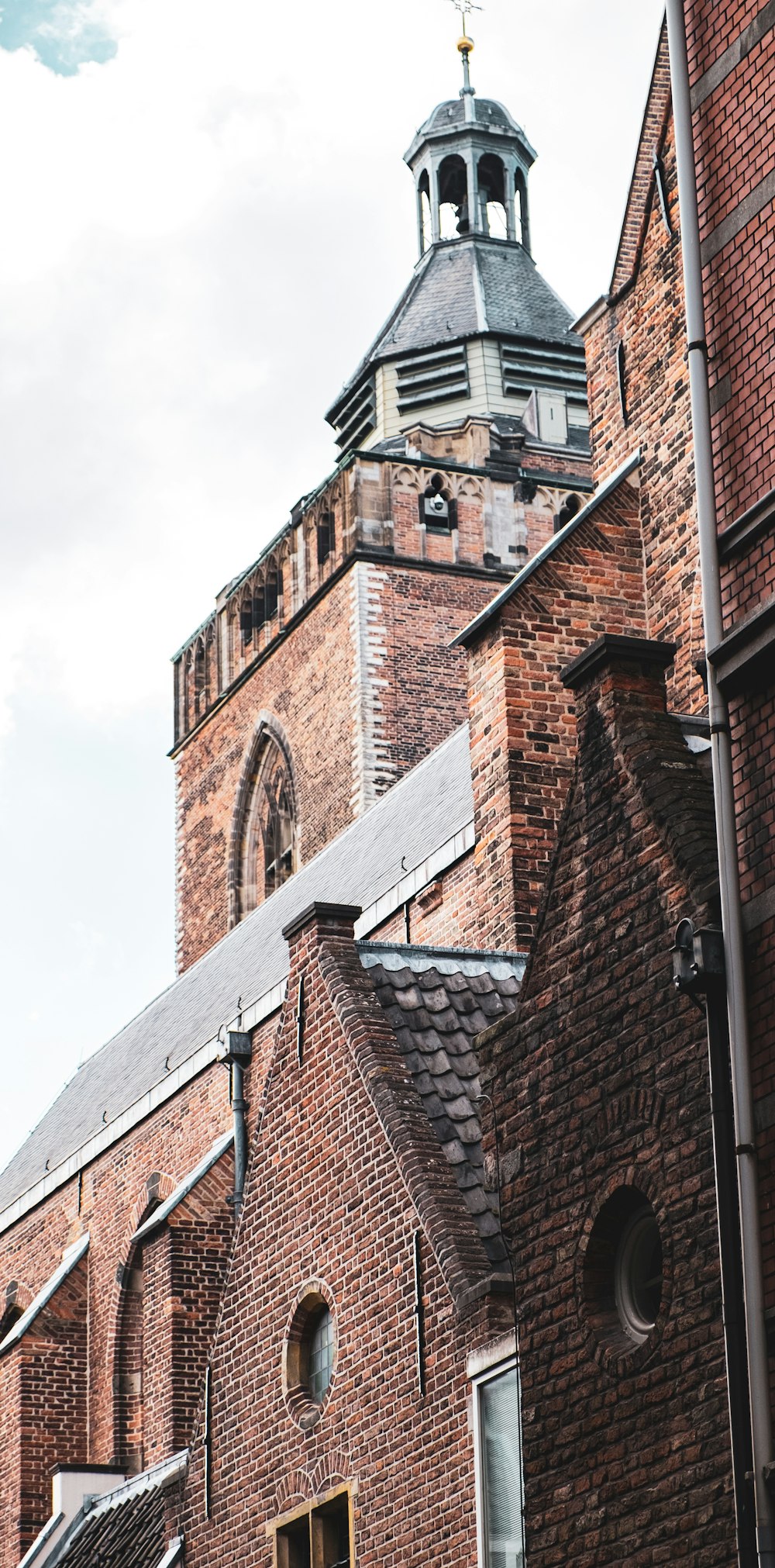 brown brick building under white sky during daytime