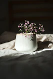 Delicate ceramic flower vase showcasing warm glazes with fresh blooms inside