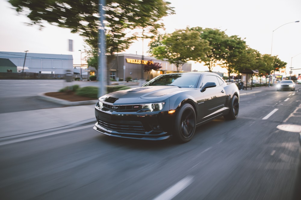 black chevrolet camaro on road during daytime