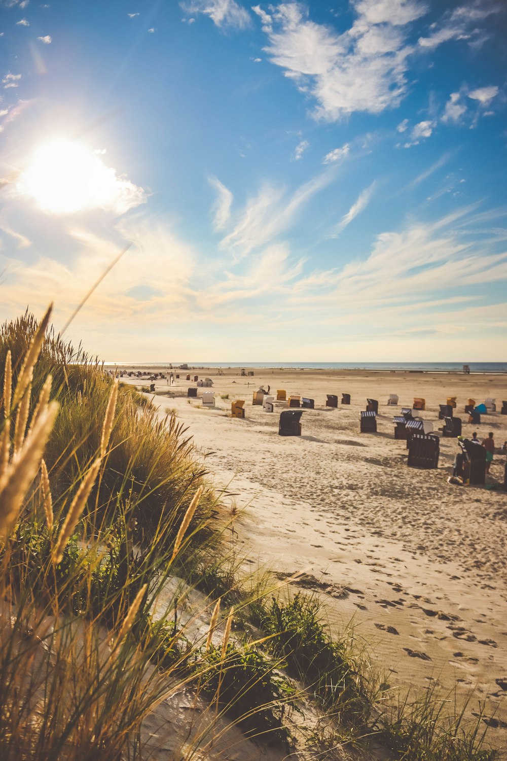 brown wooden chairs on beach during daytime