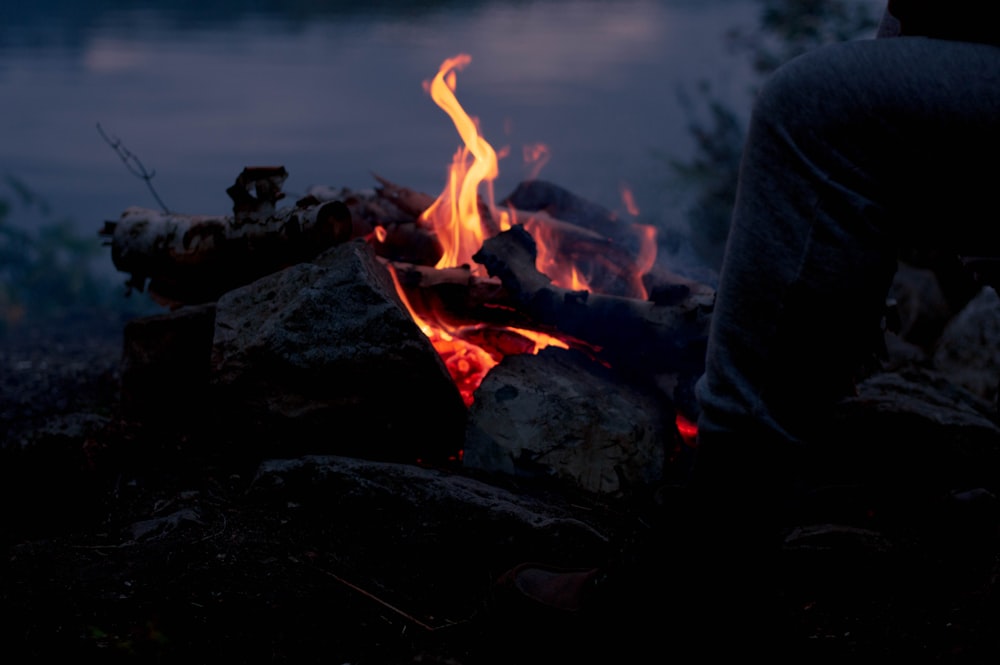 person in black jacket holding fire