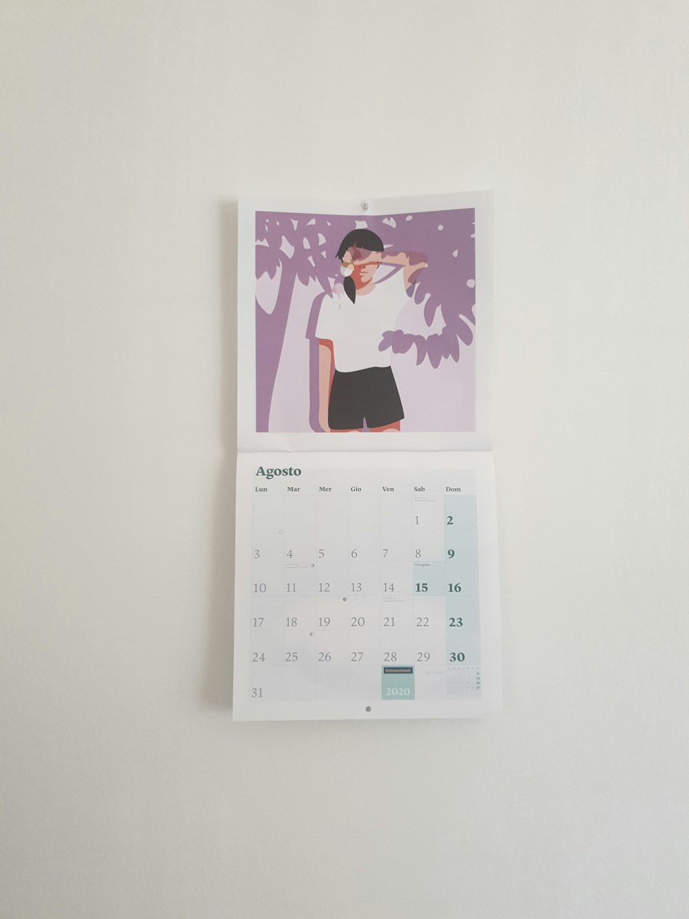 pink and white calendar on white wall