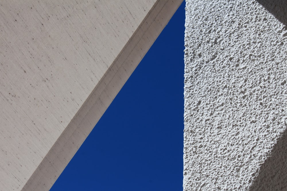 white concrete wall under blue sky during daytime