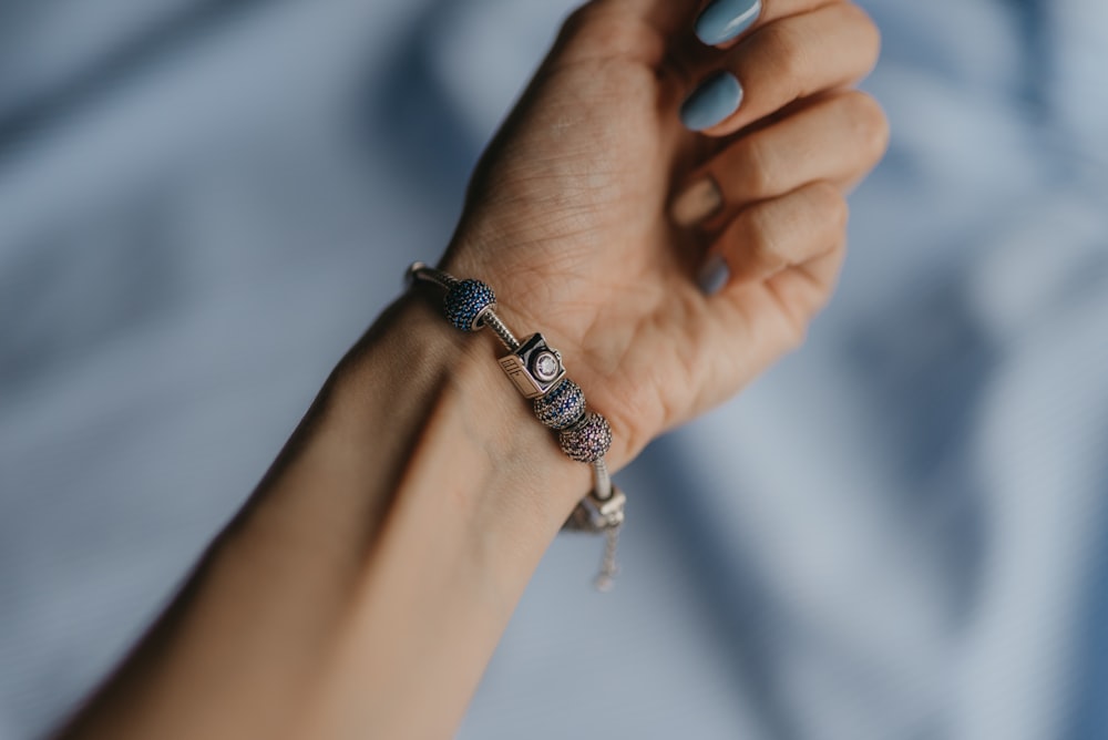 person wearing silver and black bracelet