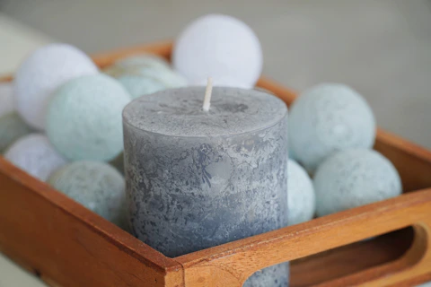white pillar candle on brown wooden holder