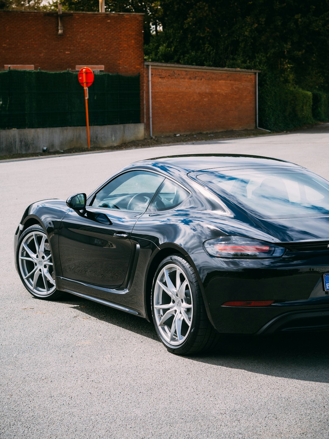 black porsche 911 parked on road during daytime