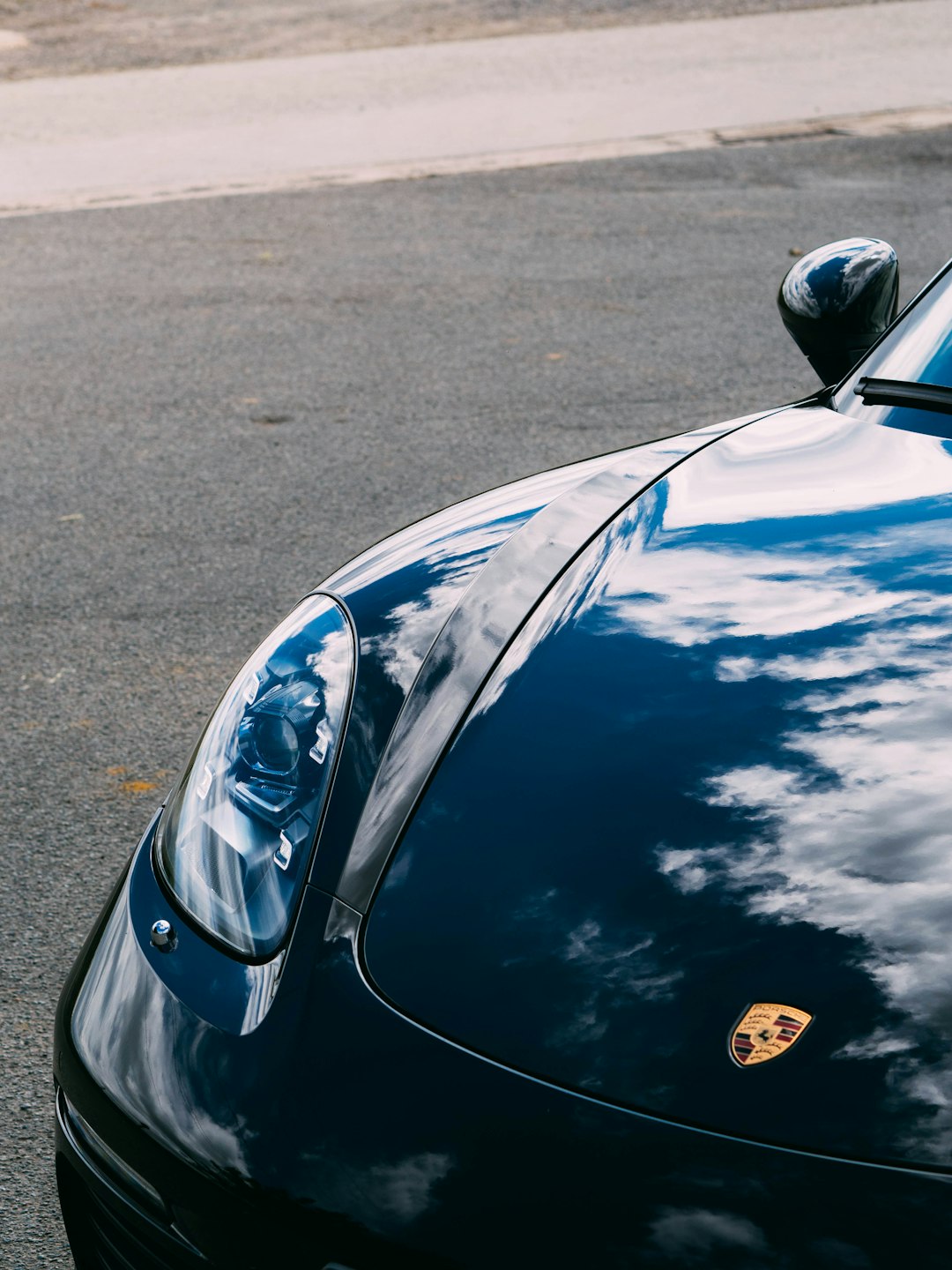 blue car on gray asphalt road during daytime