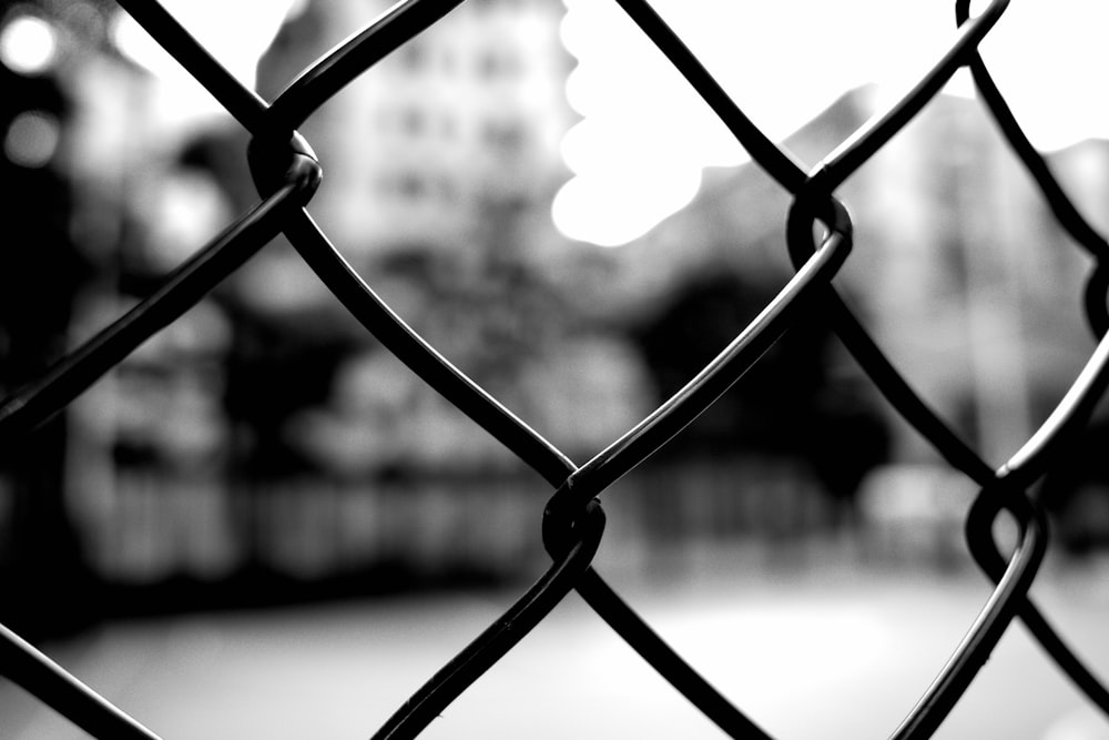 grayscale photo of chain link fence