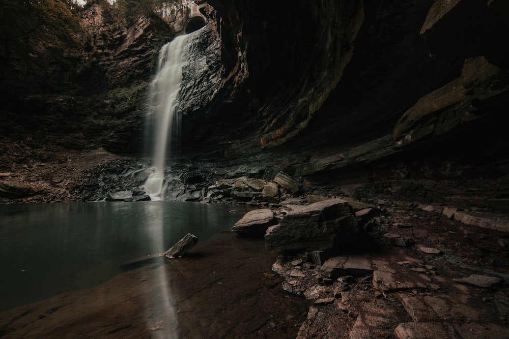 water falls in the middle of a cave