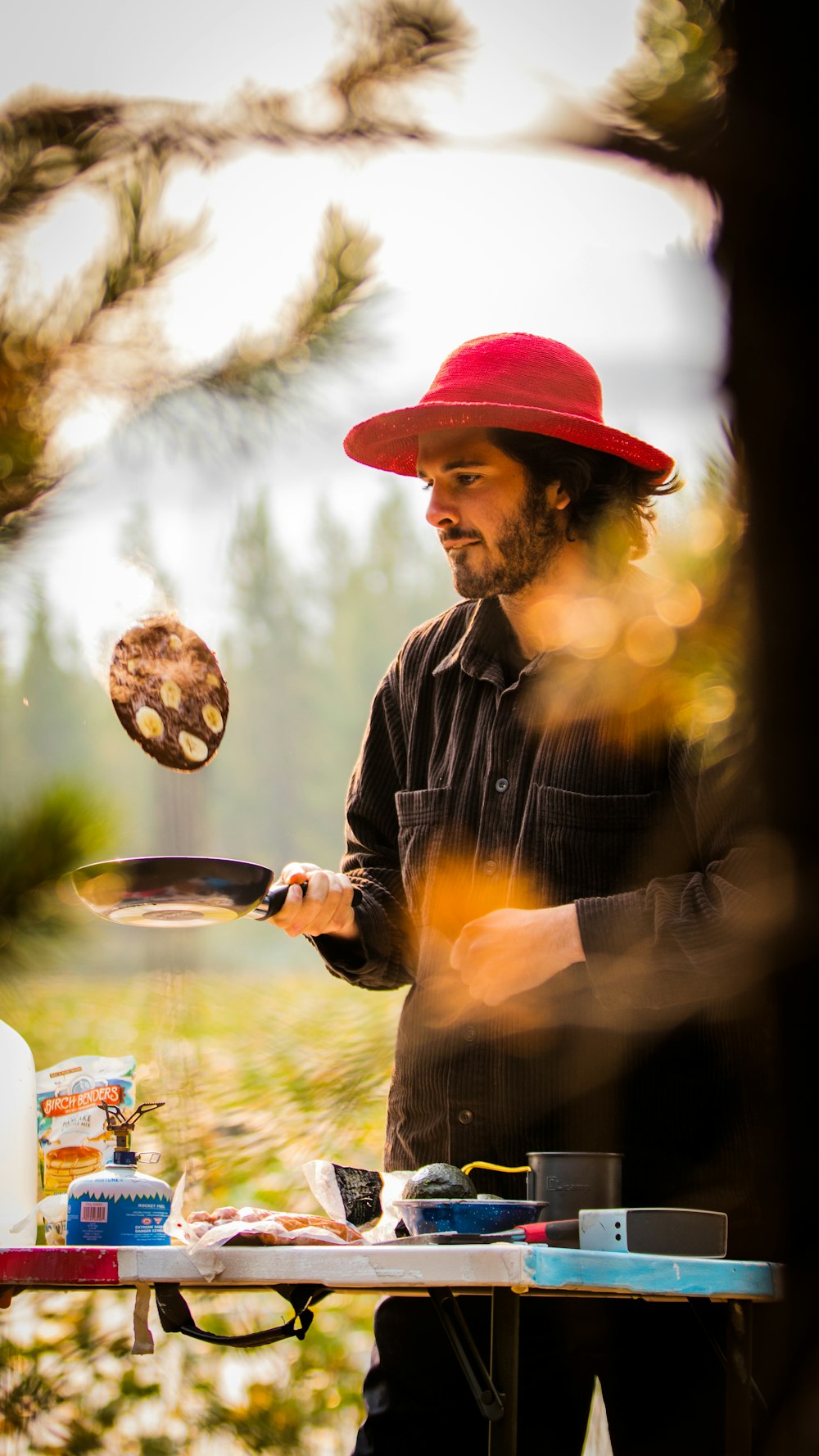 man in black and white striped long sleeve shirt holding a round plate with food during