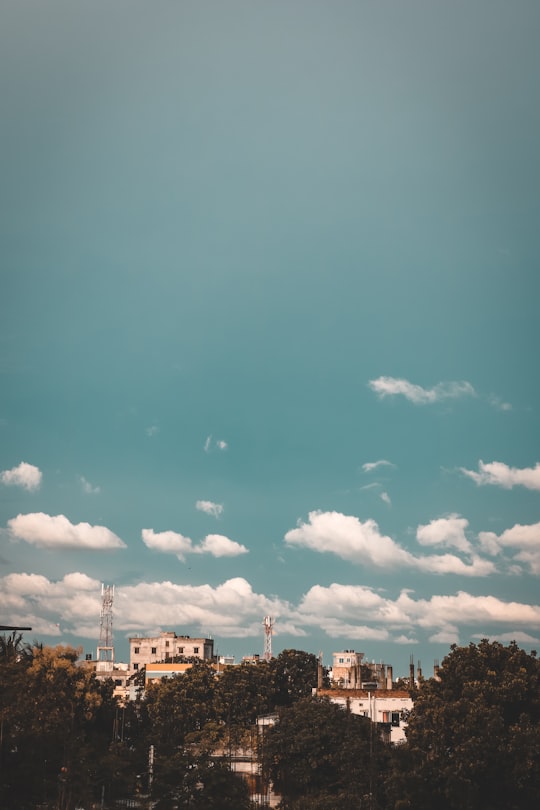 white and brown concrete building under blue sky during daytime in Rajshahi Bangladesh