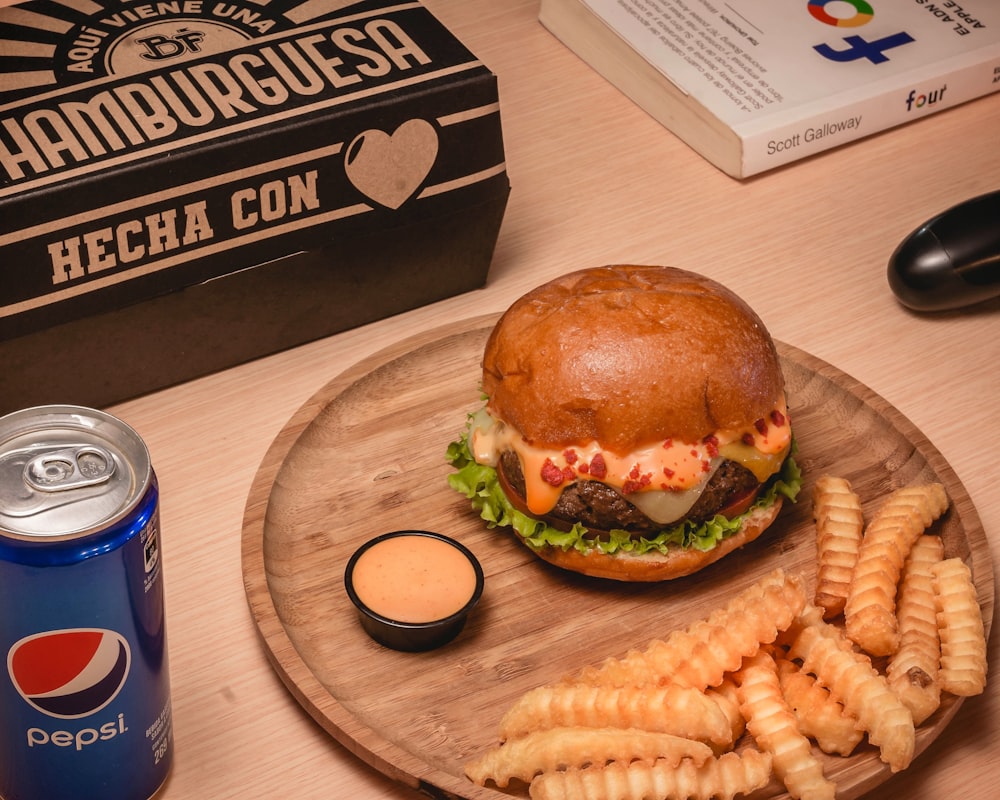 burger and fries on brown wooden table