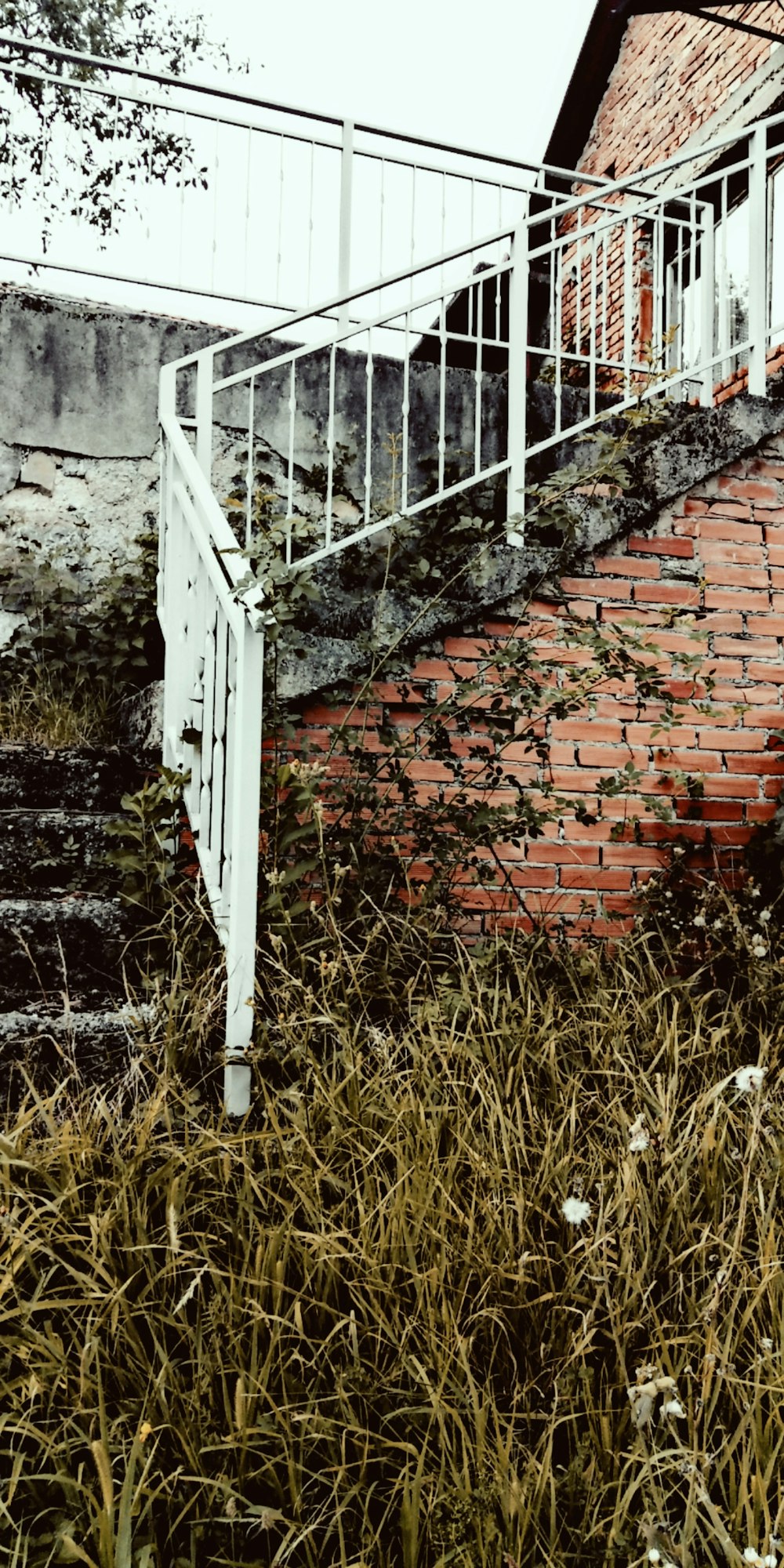 white wooden fence on brown brick wall