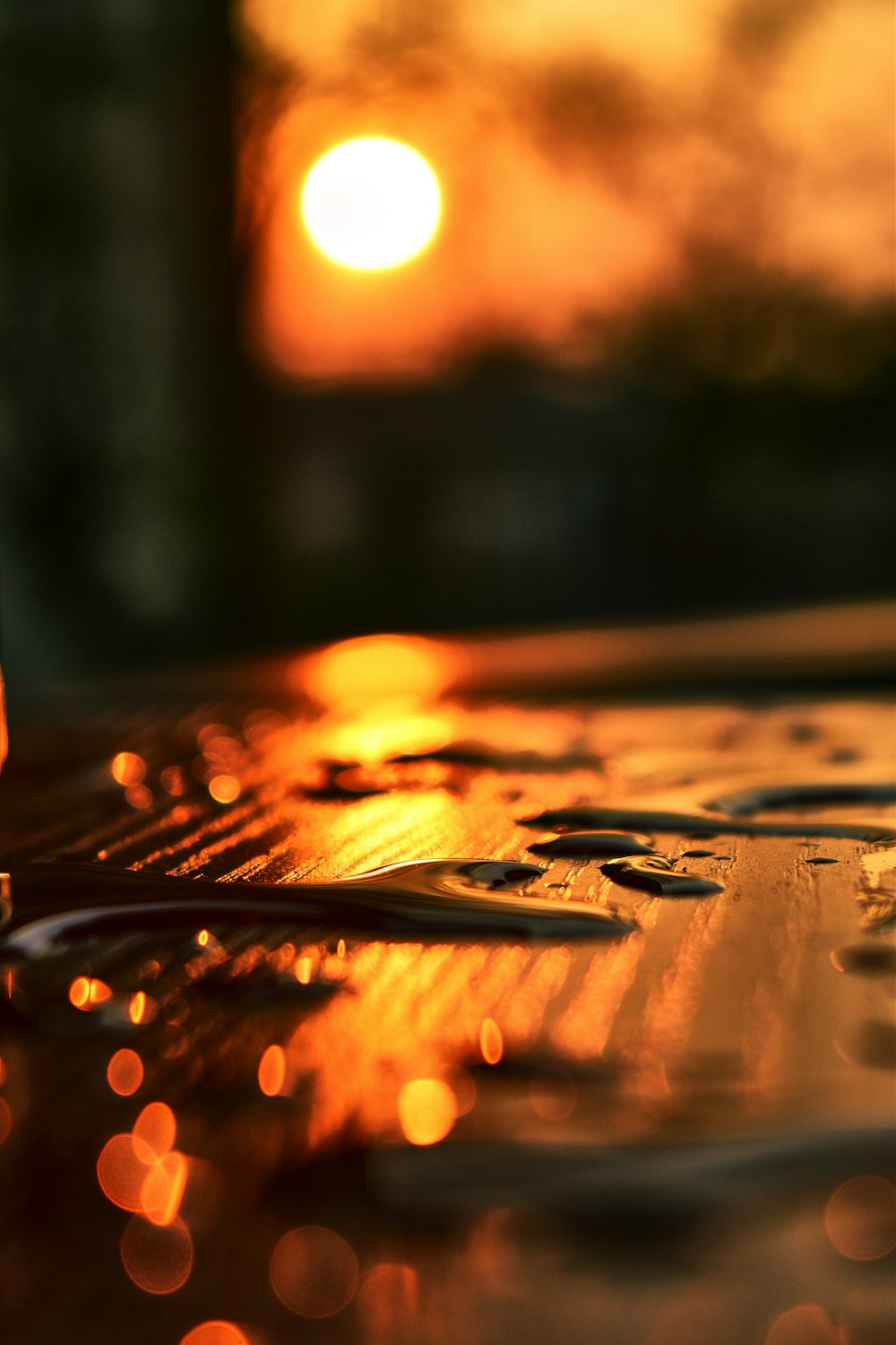 water droplets on brown wooden table