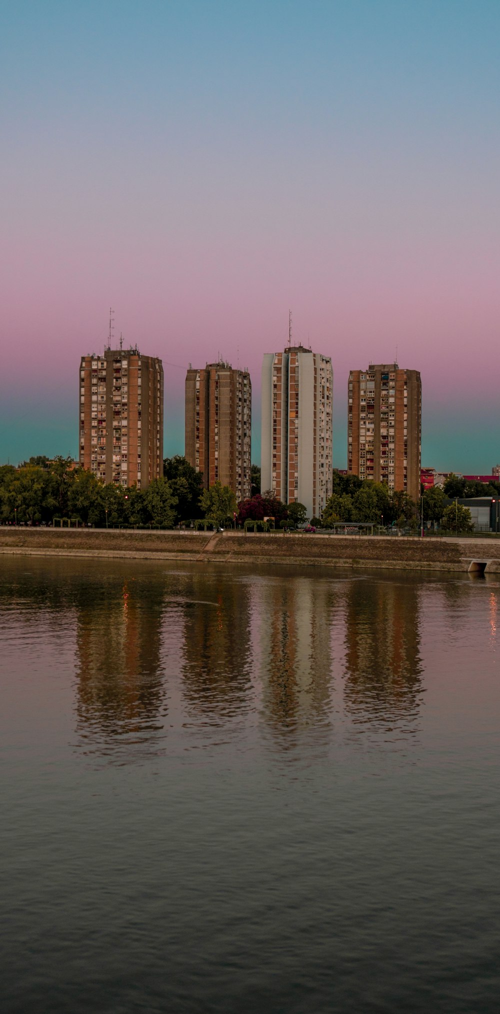 city skyline across body of water during daytime