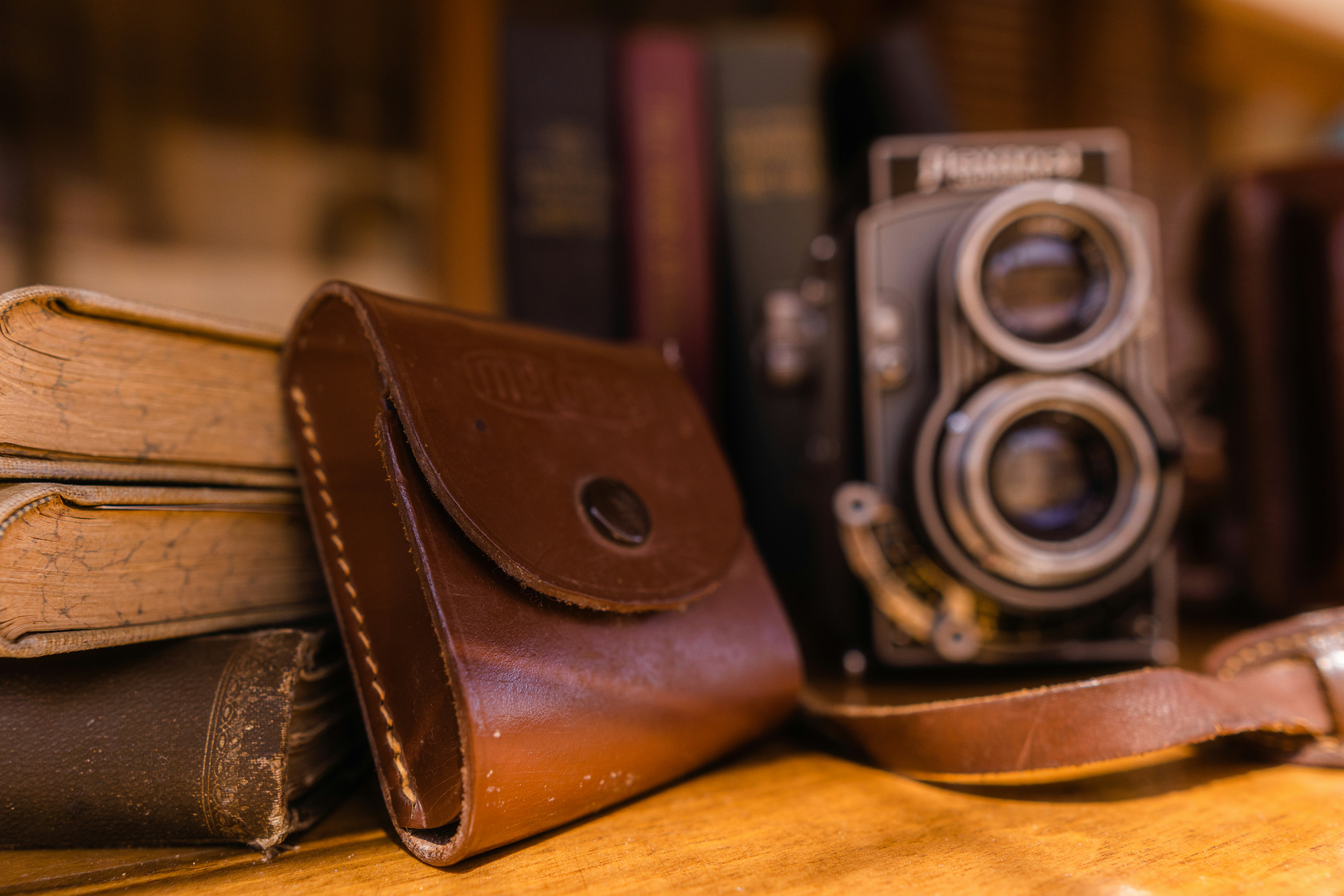 black and silver camera on brown leather bifold wallet