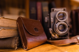 black and silver camera on brown leather bifold wallet