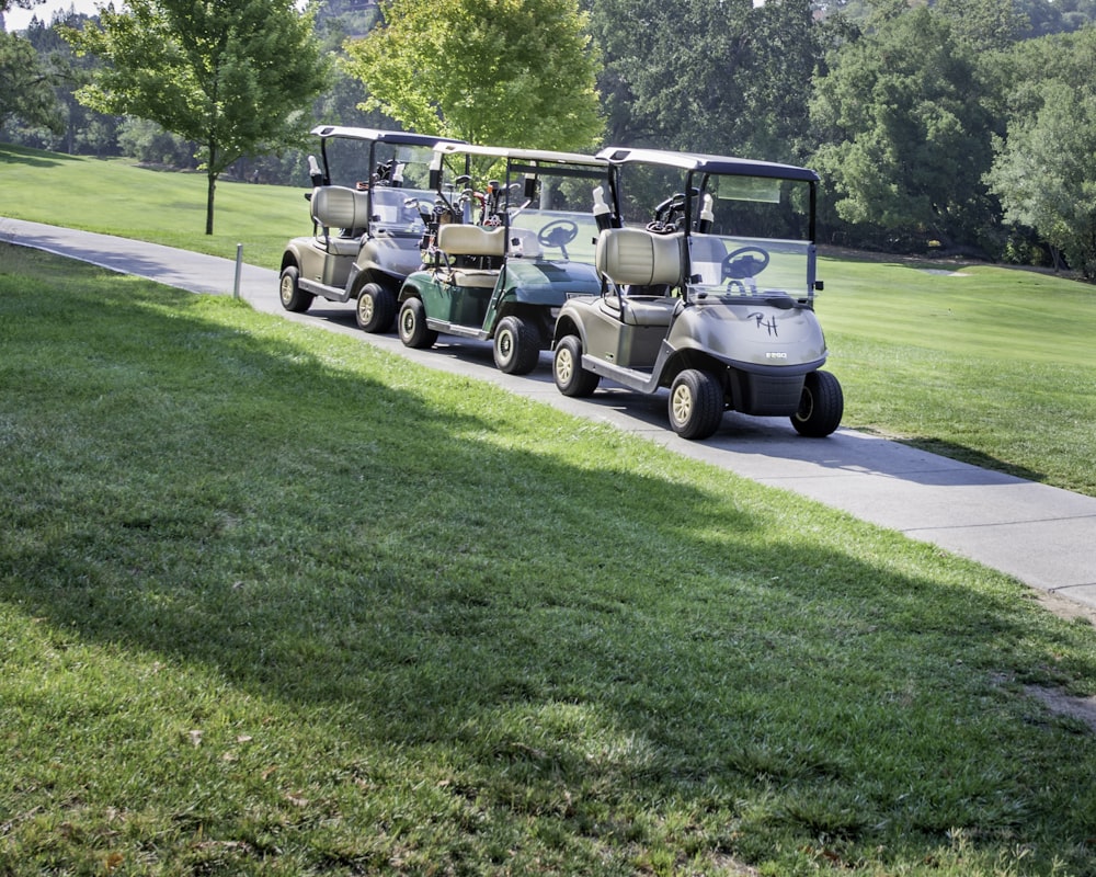 white and black golf cart on green grass field during daytime