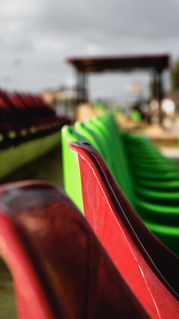 Close-up image of colorful plastic chairs and tables arranged neatly in an outdoor leisure area.