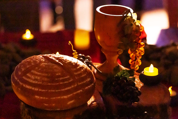 Warm, inviting scene of a family sharing injera and honey wine around a wooden table.