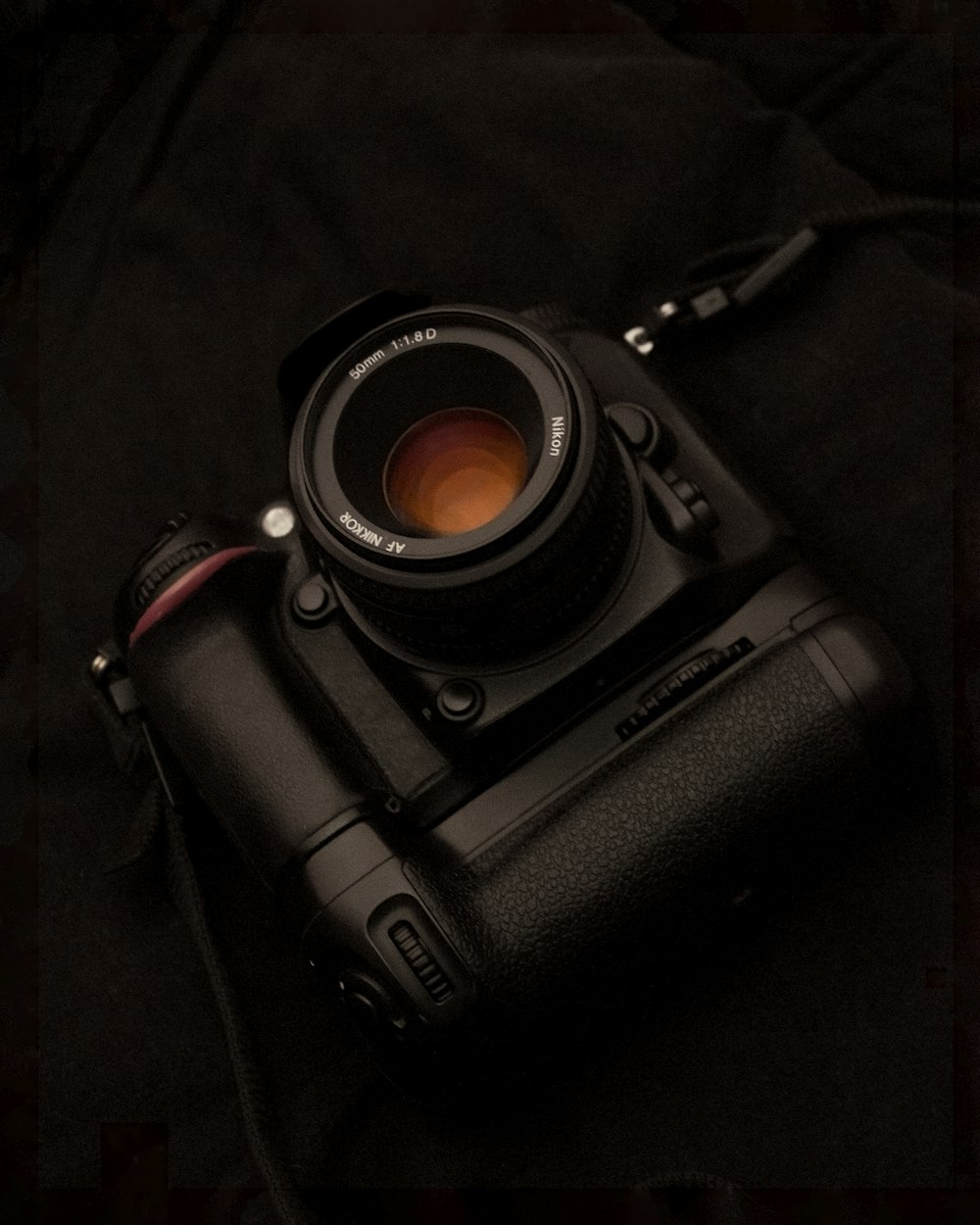 black dslr camera on black textile