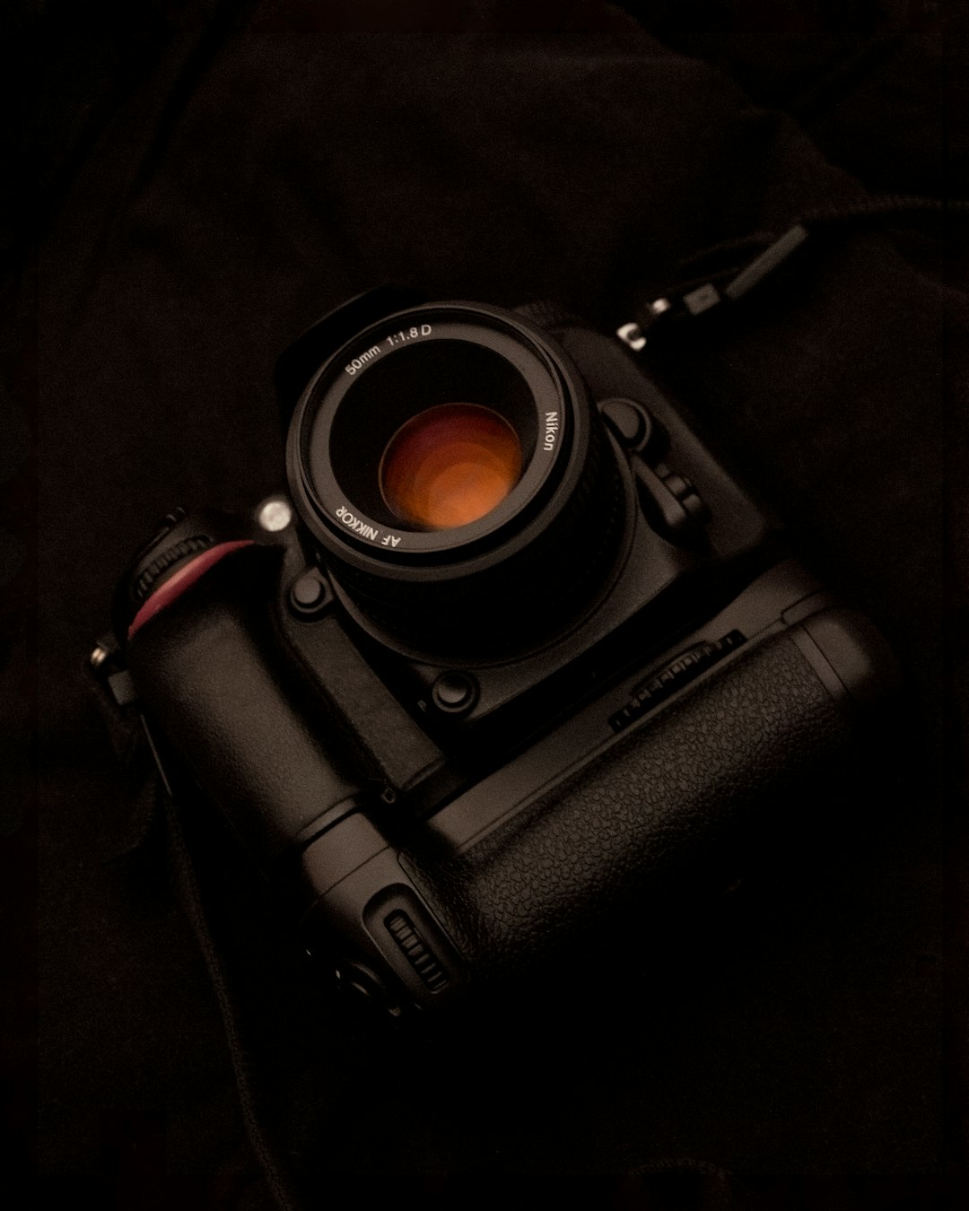 black dslr camera on black textile