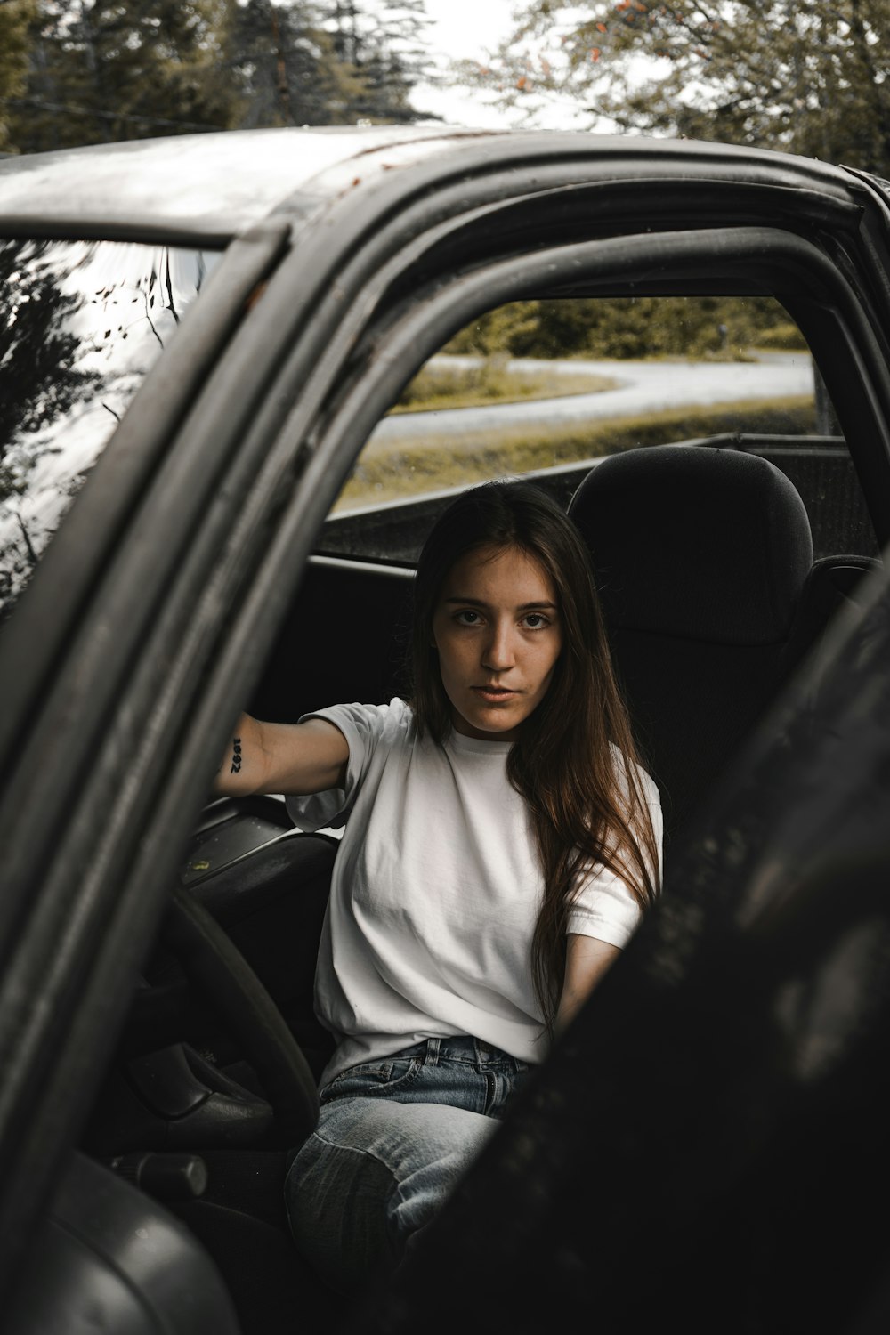 woman in white shirt sitting inside car