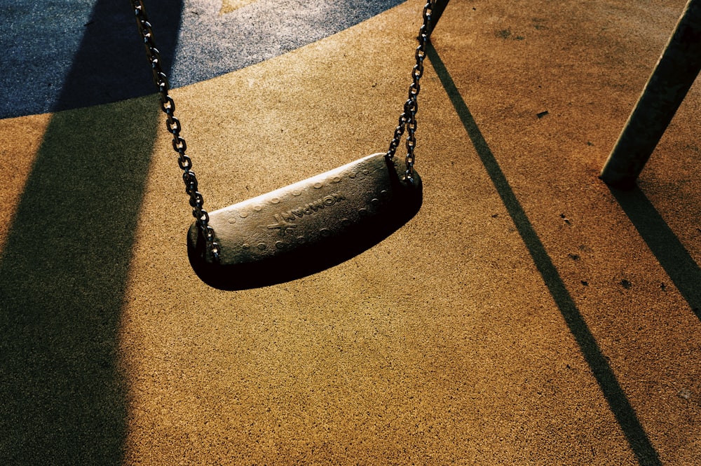 black metal swing on brown concrete floor