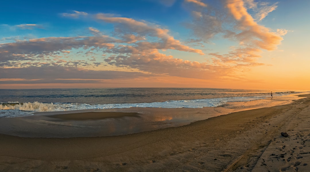 sea waves crashing on shore during sunset