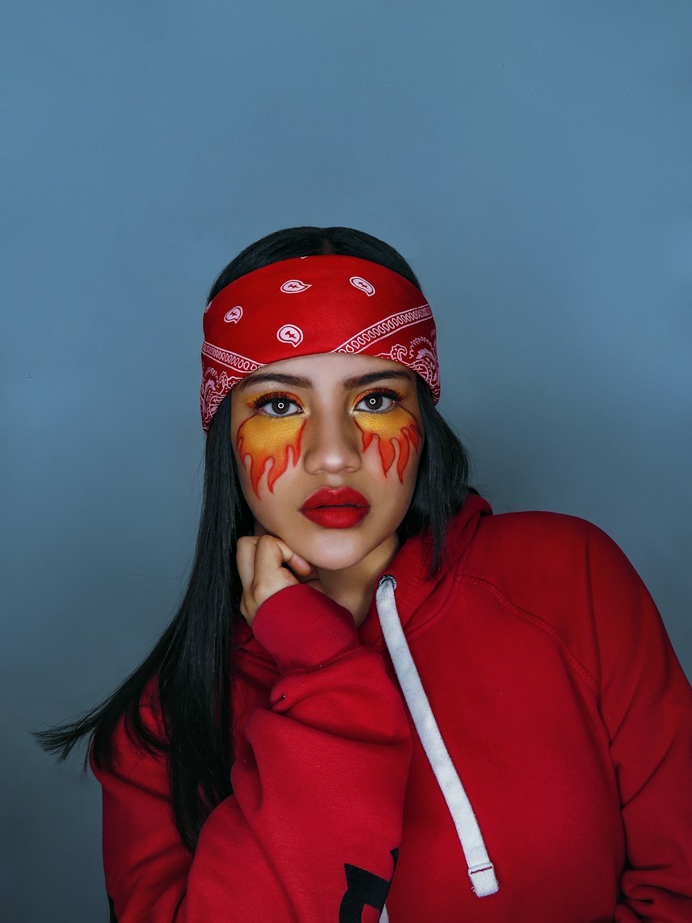 woman in red hoodie wearing red knit cap