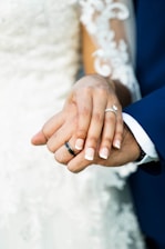man and woman wearing silver wedding band