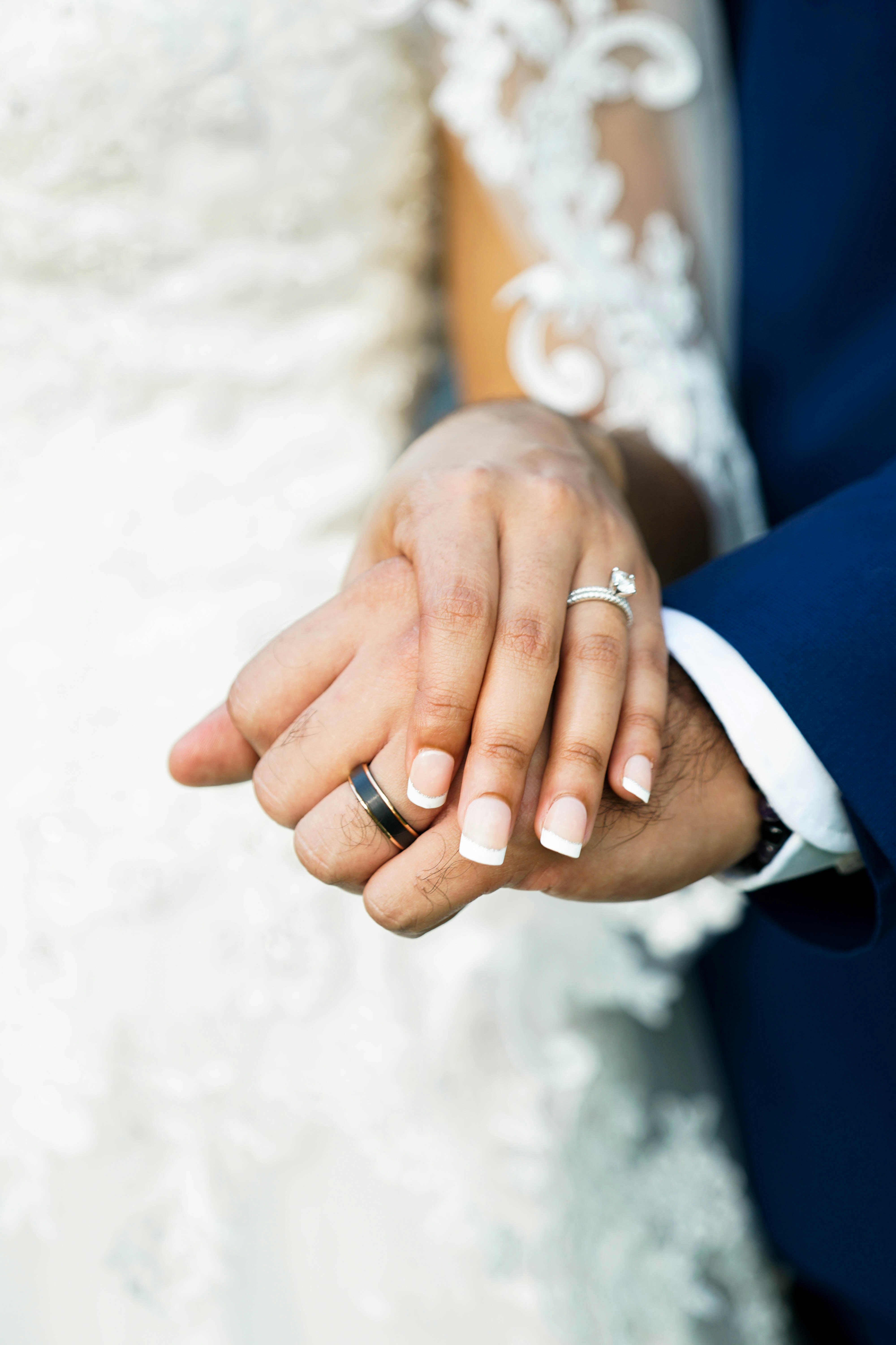 man and woman wearing silver wedding band