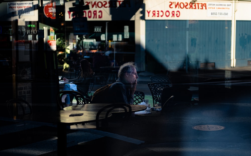 woman in black jacket sitting on black metal chair