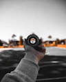 person holding black camera lens