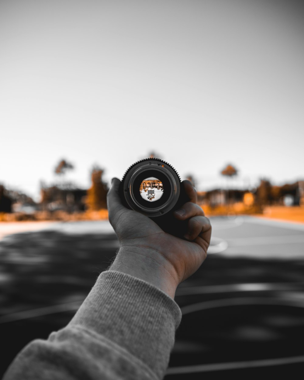 person holding black camera lens