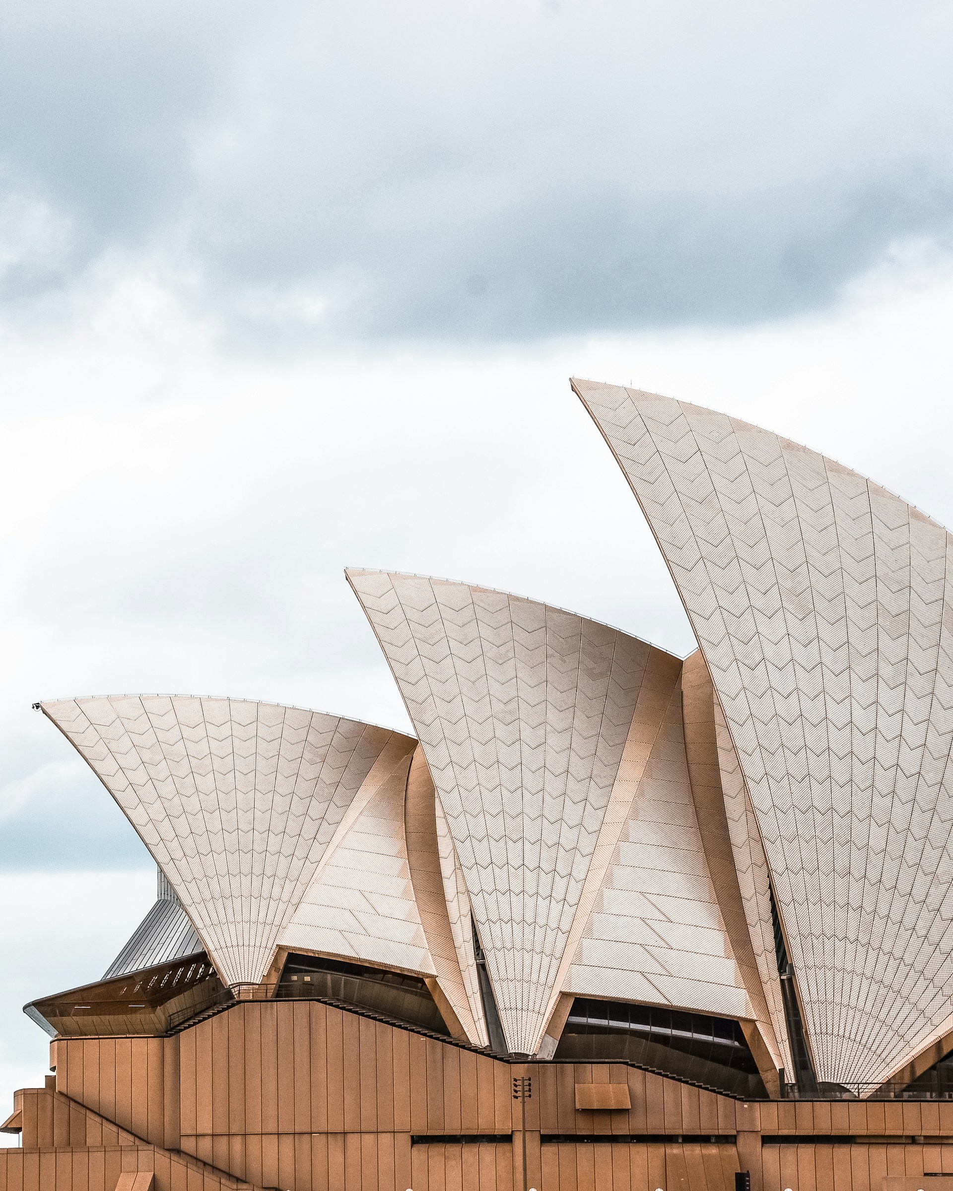brown and white building under white clouds during daytime