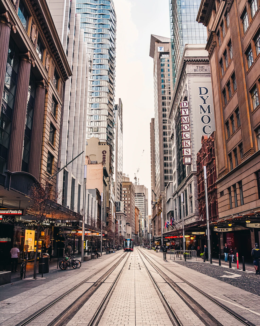 People walking between high-rise office buildings in a city centre