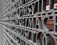 Detailed shot of cut-out letters mounted on a textured wall.