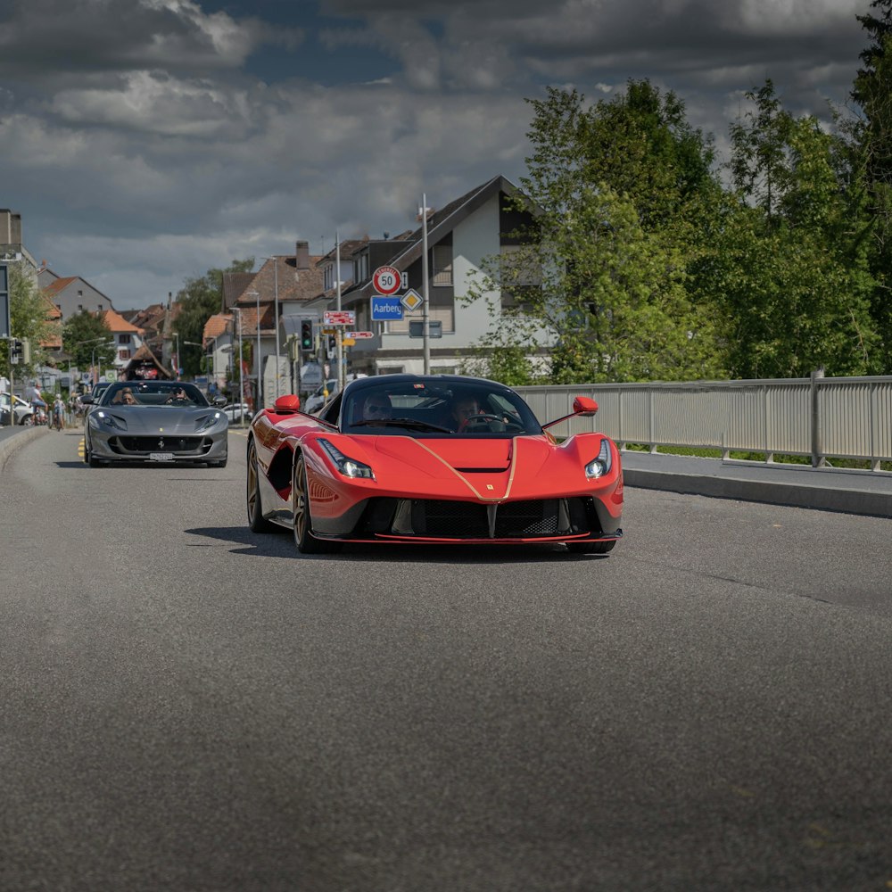 red ferrari sports car on road during daytime