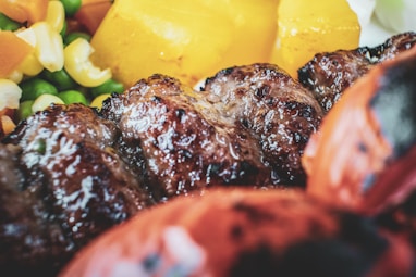cooked meat with sliced fruits
