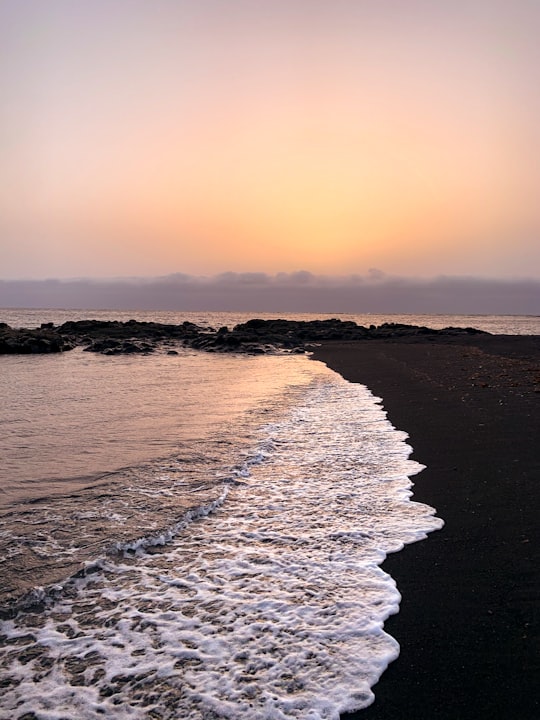 ocean waves crashing on shore during sunset in Canary Islands Spain