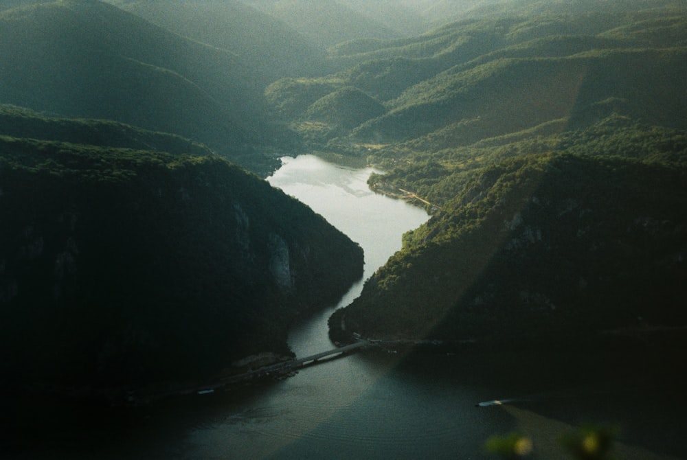 aerial view of green mountains and lake