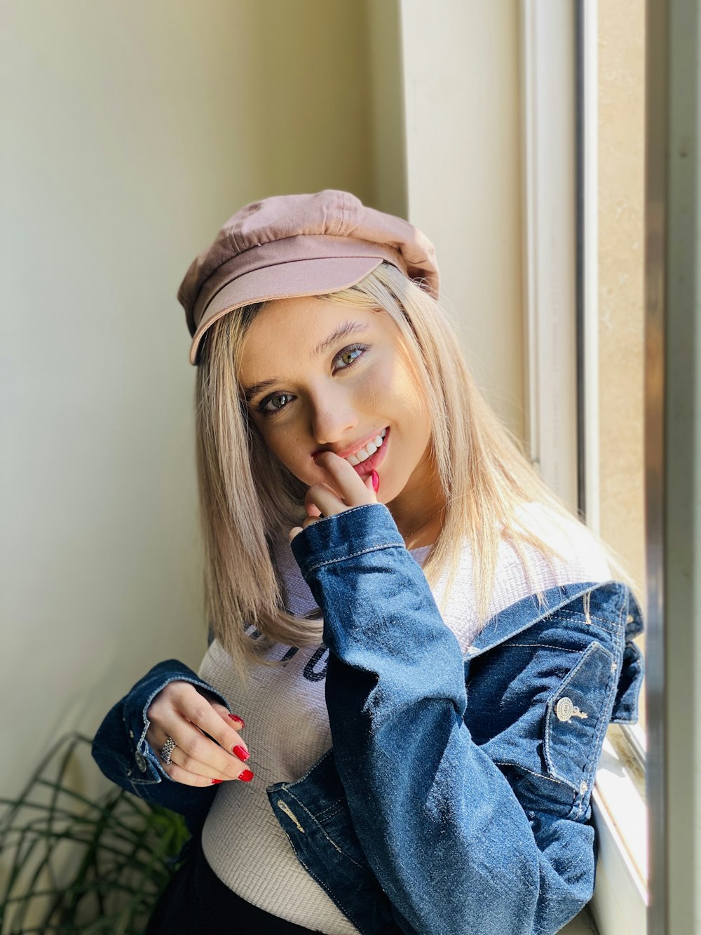 woman in blue denim jacket wearing pink hat