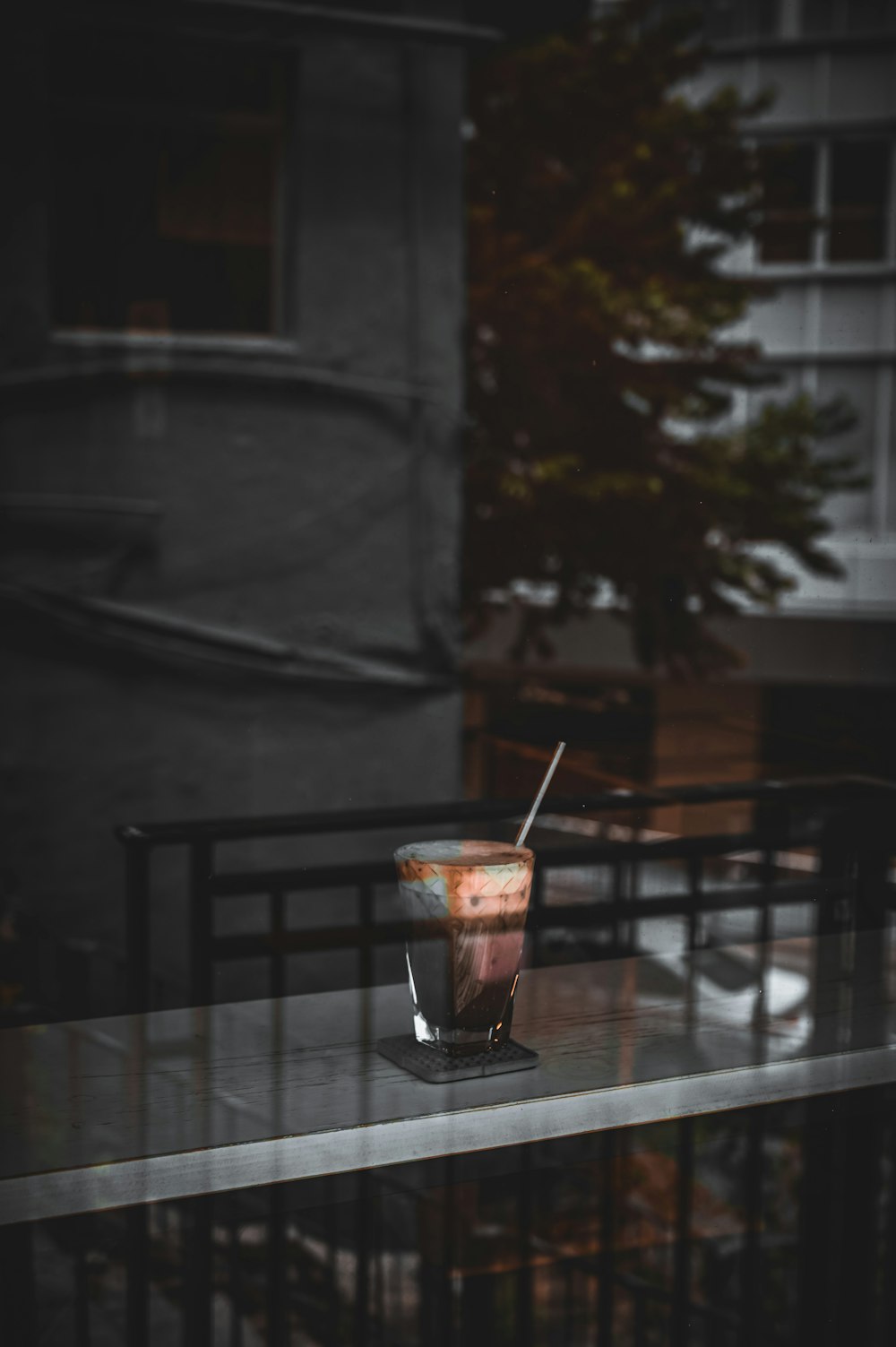 clear plastic cup with orange liquid on brown wooden table