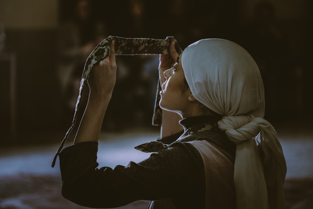 woman in white hijab and black long sleeve shirt